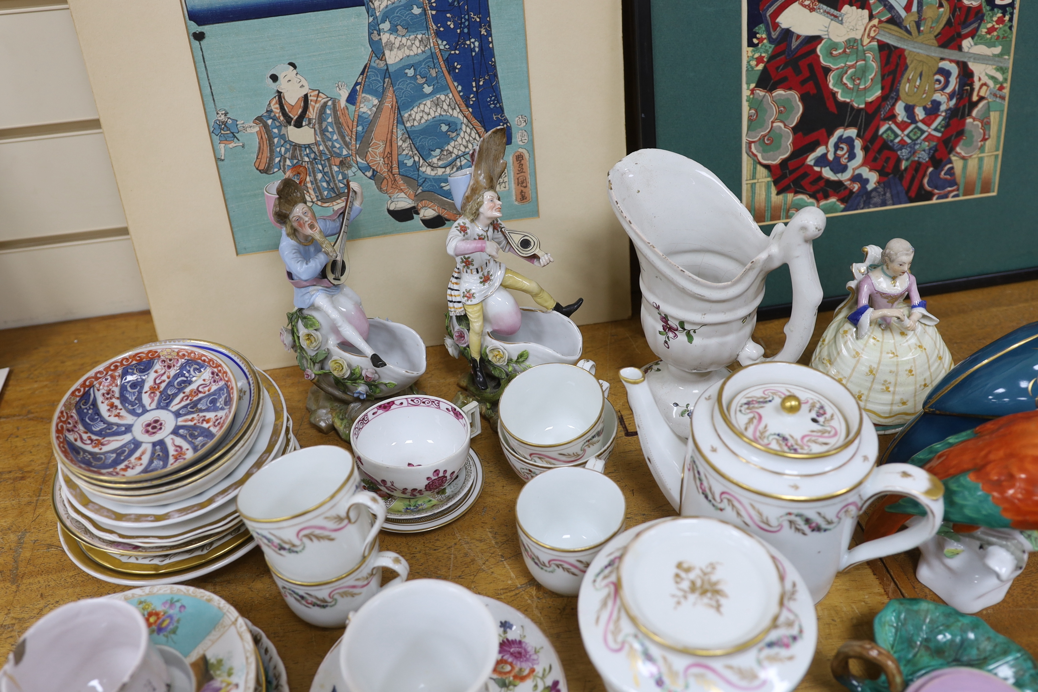 Assorted Continental ceramics, mainly 19th century, including two figures of parrots, two candle holders in the form of musicians, a teapot, jugs, various cups and sauces, etc.